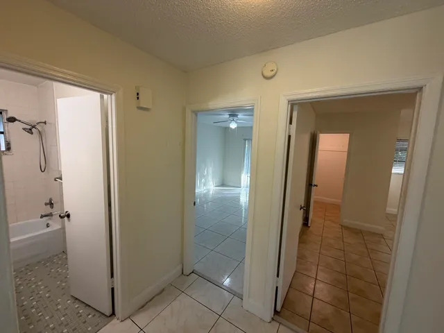 a view of a bathroom from a corridor