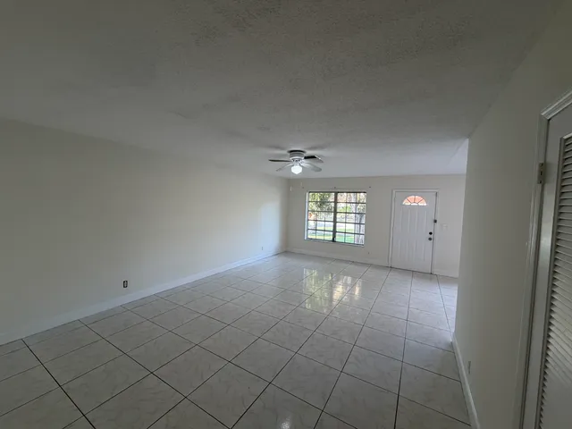 an empty room with windows and entrance