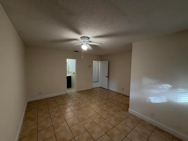 an empty room with projector and fan