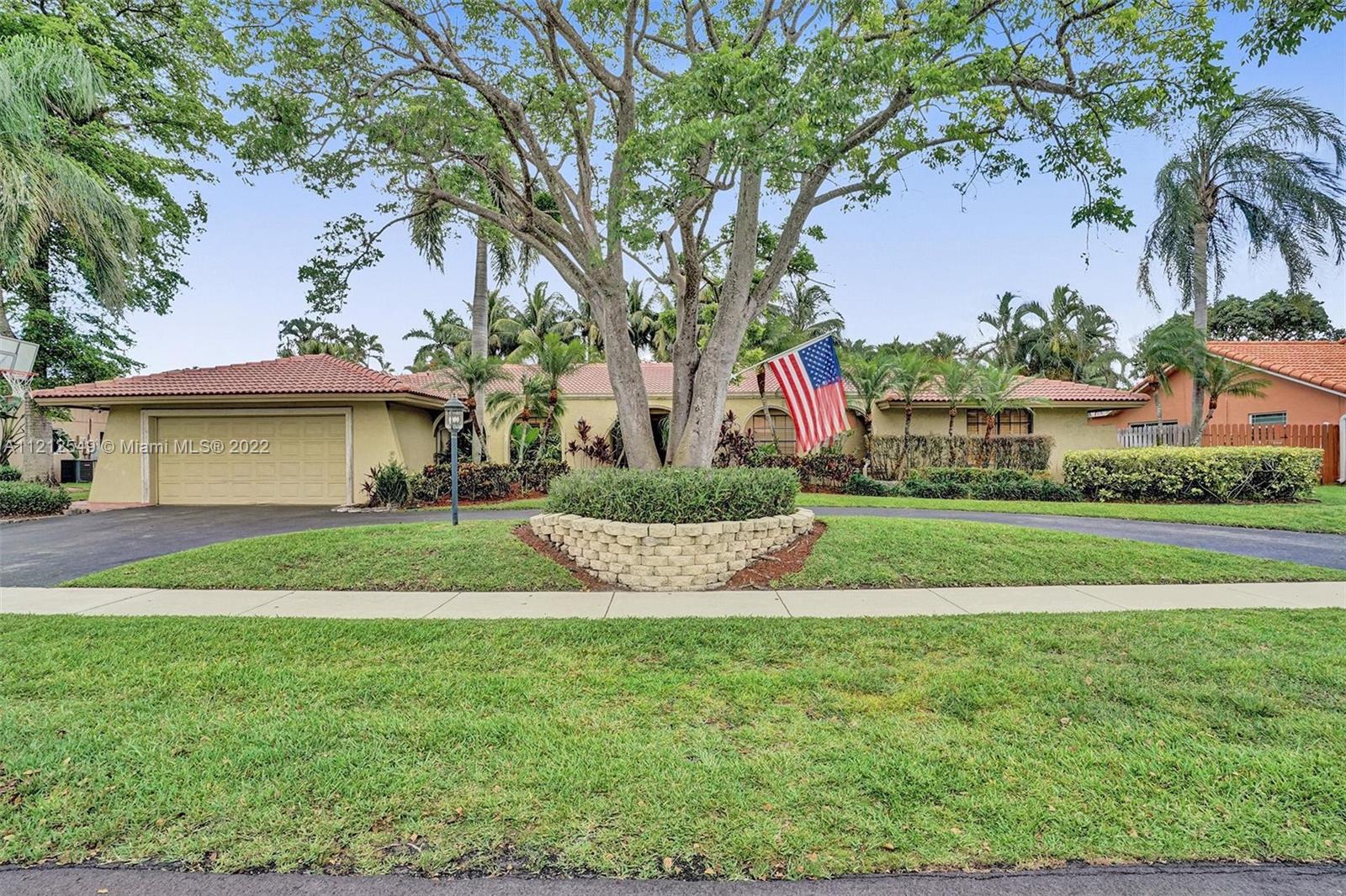 7360 Southwest 16th Street Plantation, FL 33317 - Photo 1 of 70 a view of a white house with a yard and palm trees