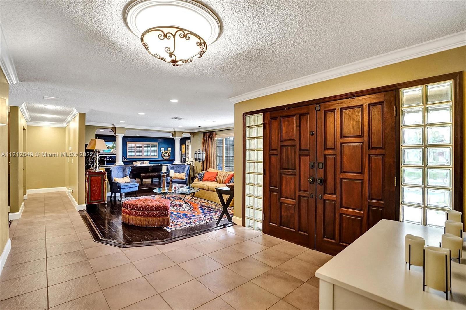 7360 Southwest 16th Street Plantation, FL 33317 - Photo 11 of 70 a living room with furniture a chandelier and a large window