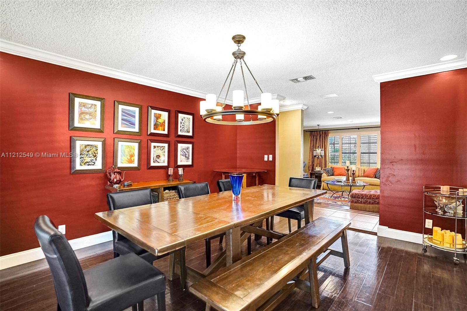 7360 Southwest 16th Street Plantation, FL 33317 - Photo 14 of 70 a dining room with furniture a chandelier and wooden floor