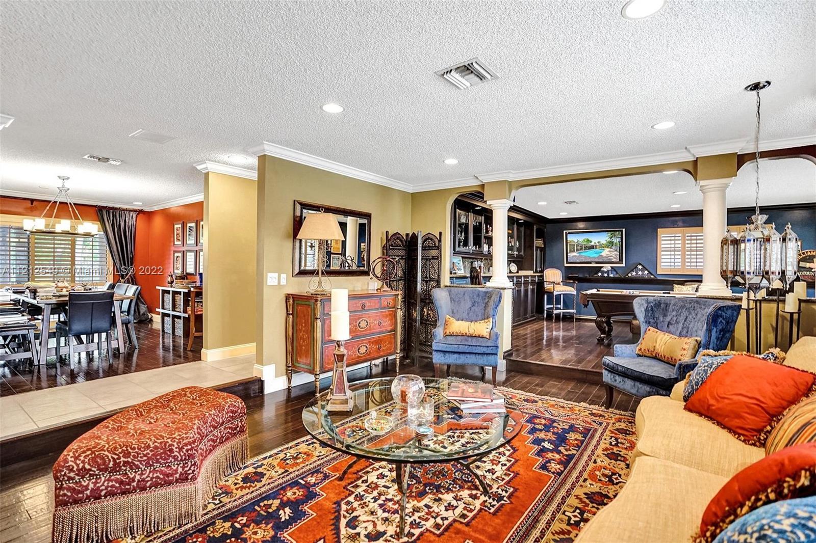 7360 Southwest 16th Street Plantation, FL 33317 - Photo 17 of 70 a living room with furniture a wooden floor and kitchen view