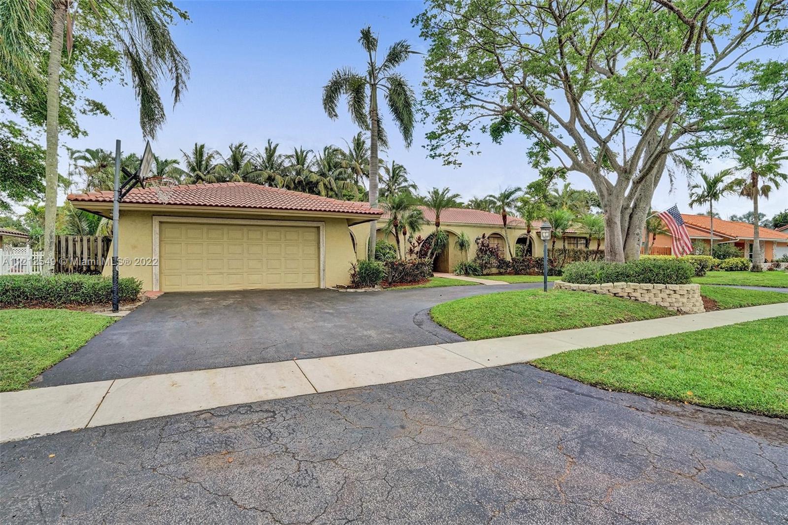 7360 Southwest 16th Street Plantation, FL 33317 - Photo 2 of 70 a front view of a house with a yard and garage
