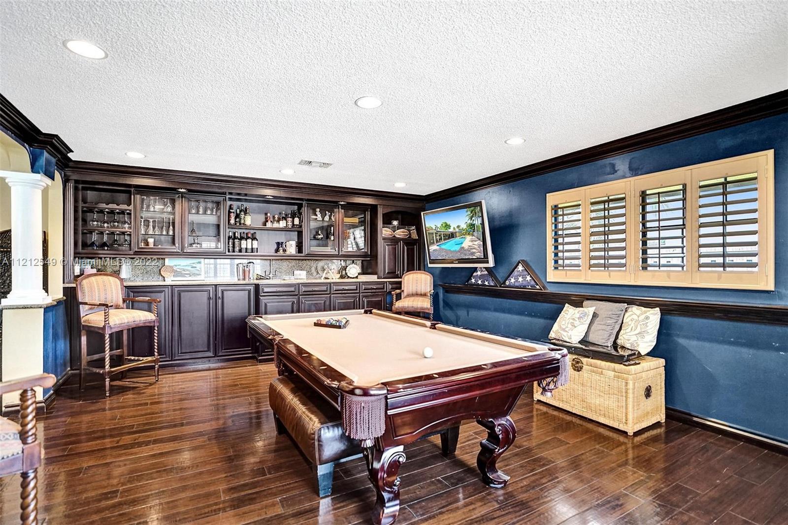 7360 Southwest 16th Street Plantation, FL 33317 - Photo 21 of 70 a living room with a table chairs and a wooden floor