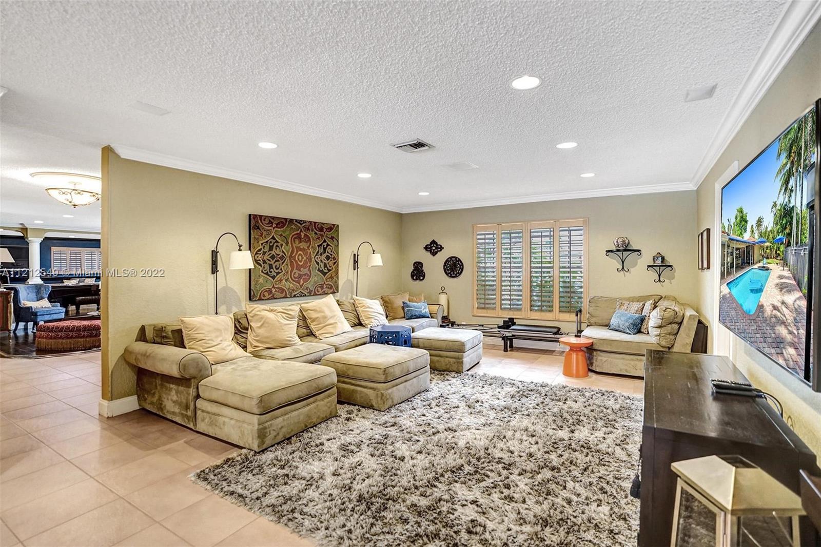 7360 Southwest 16th Street Plantation, FL 33317 - Photo 26 of 70 a living room with furniture and a flat screen tv