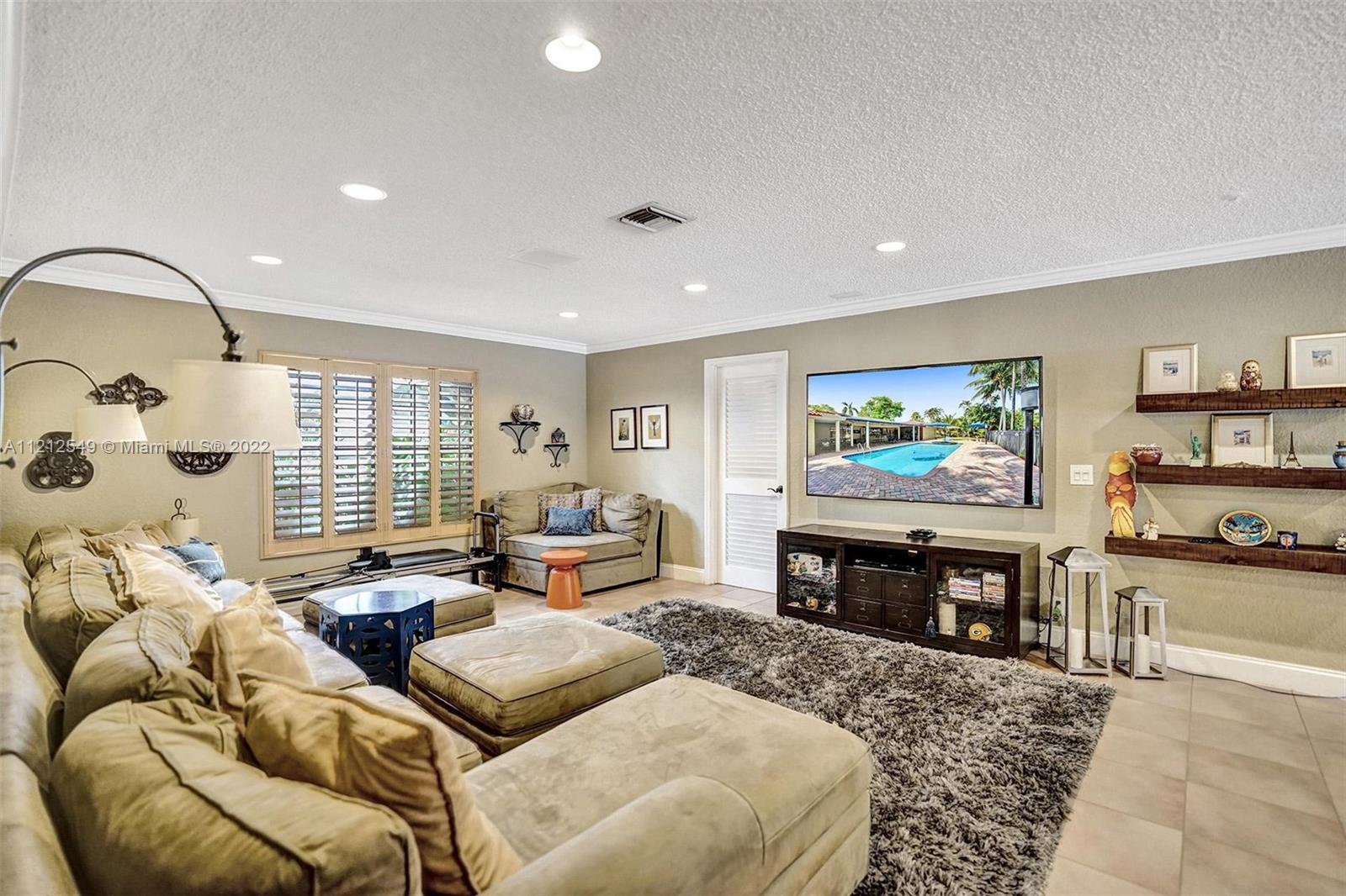 7360 Southwest 16th Street Plantation, FL 33317 - Photo 28 of 70 a living room with furniture and a flat screen tv