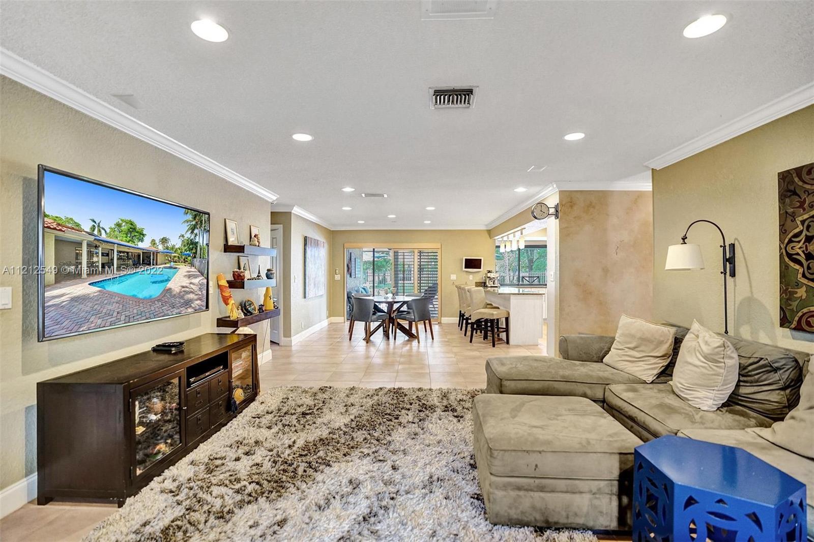 7360 Southwest 16th Street Plantation, FL 33317 - Photo 29 of 70 a living room with furniture and a flat screen tv