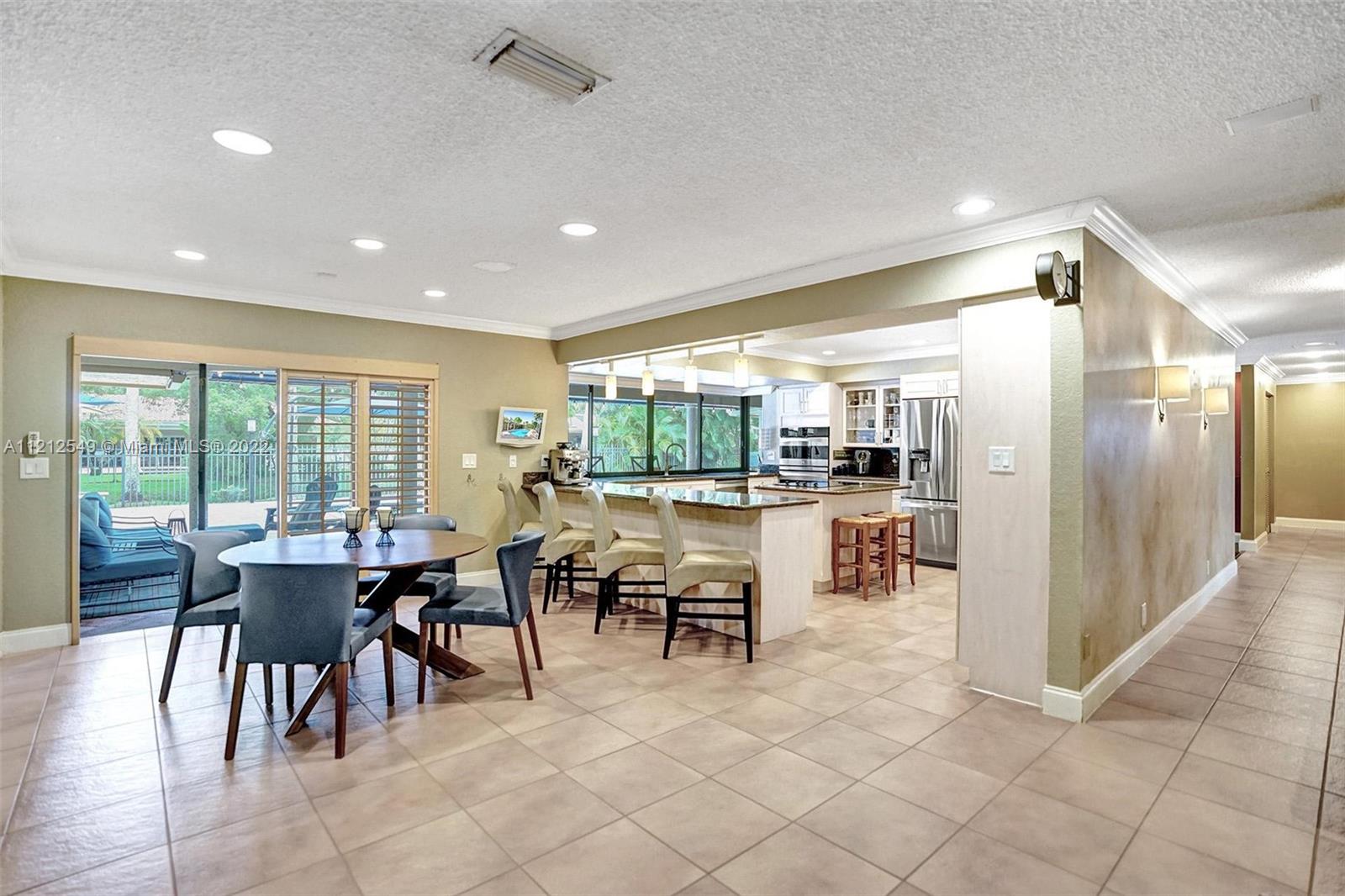 7360 Southwest 16th Street Plantation, FL 33317 - Photo 30 of 70 a outdoor space with lots of tables a large window and chairs