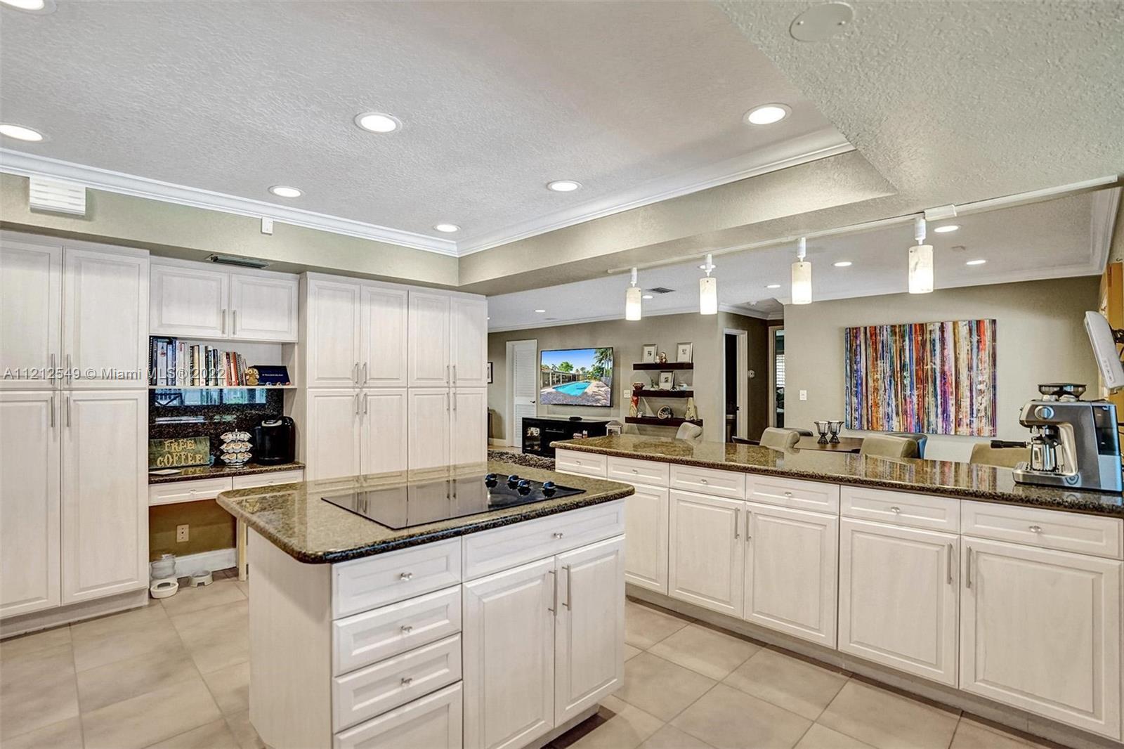 7360 Southwest 16th Street Plantation, FL 33317 - Photo 39 of 70 a kitchen with stainless steel appliances granite countertop a sink and cabinets