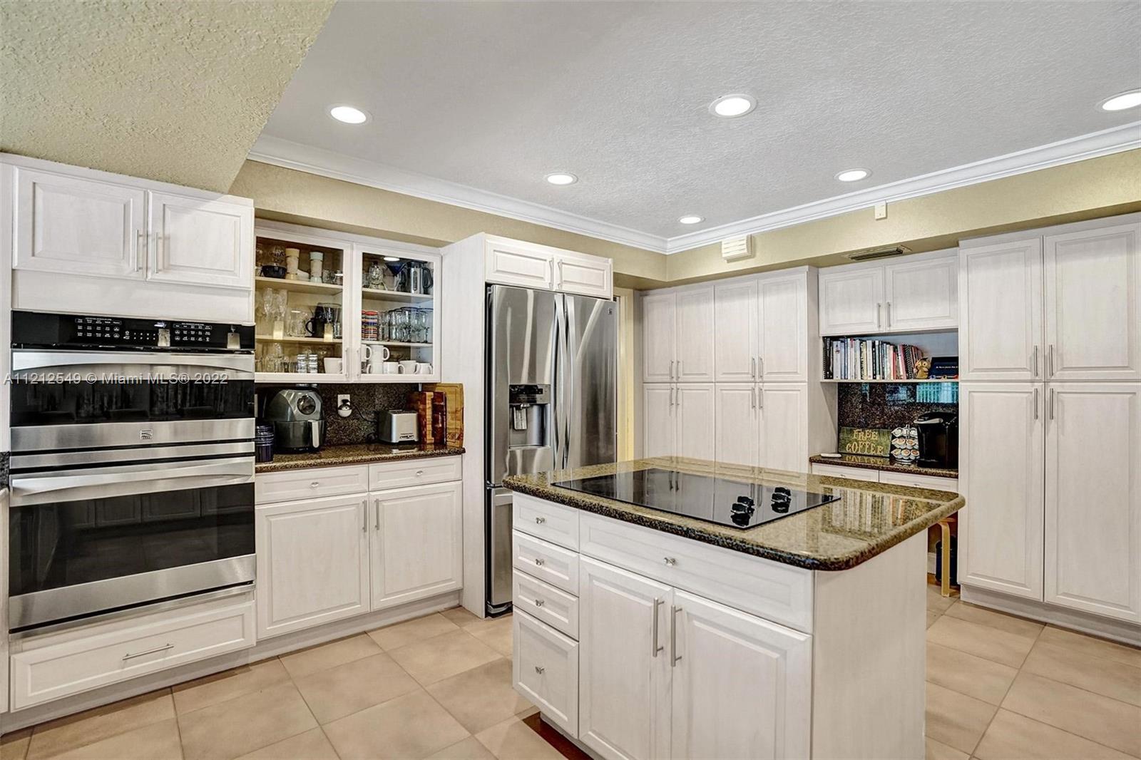 7360 Southwest 16th Street Plantation, FL 33317 - Photo 40 of 70 a kitchen that has a sink and a stove