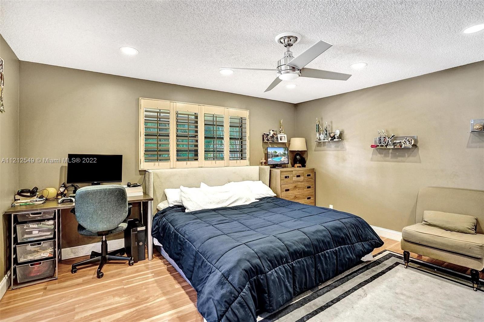 7360 Southwest 16th Street Plantation, FL 33317 - Photo 44 of 70 a spacious bedroom with a bed and a desk