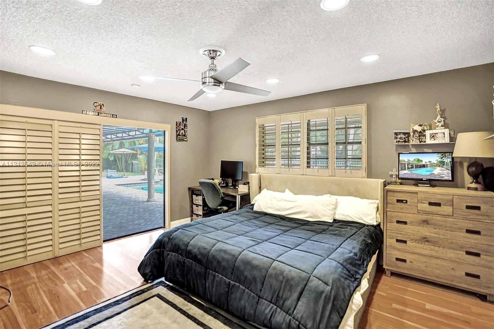 7360 Southwest 16th Street Plantation, FL 33317 - Photo 46 of 70 a bedroom with a bed and a dresser
