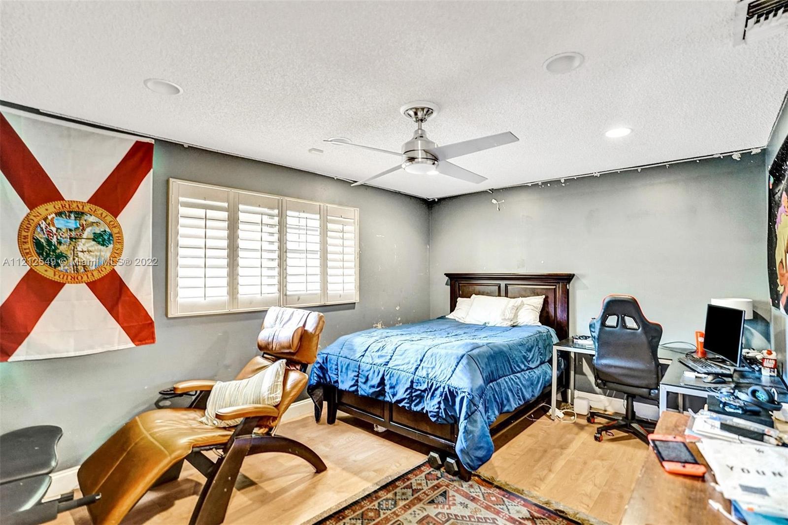 7360 Southwest 16th Street Plantation, FL 33317 - Photo 47 of 70 a bedroom with a bed and a window