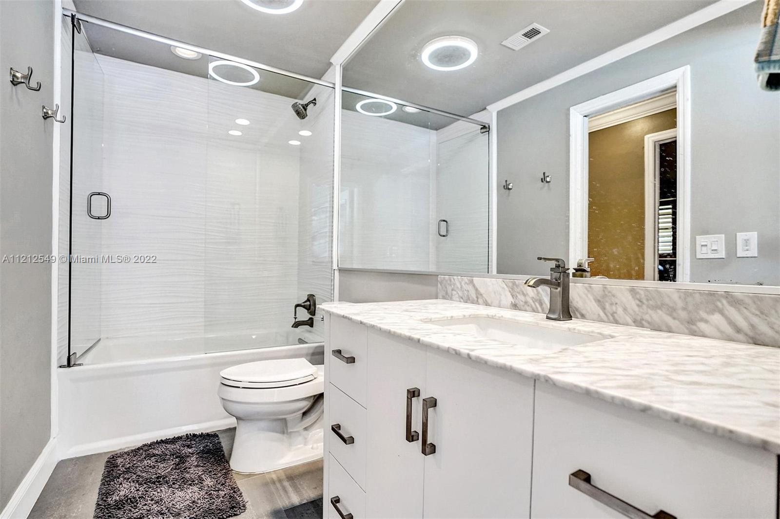 7360 Southwest 16th Street Plantation, FL 33317 - Photo 48 of 70 a bathroom with a granite countertop sink toilet and shower