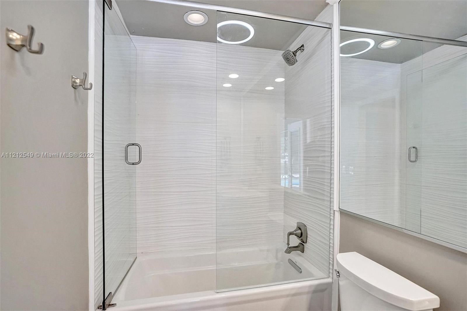 7360 Southwest 16th Street Plantation, FL 33317 - Photo 49 of 70 a bathroom with a bathtub and a shower