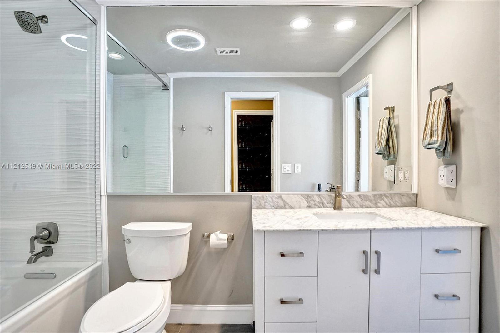 7360 Southwest 16th Street Plantation, FL 33317 - Photo 50 of 70 a bathroom with a granite countertop sink toilet and shower