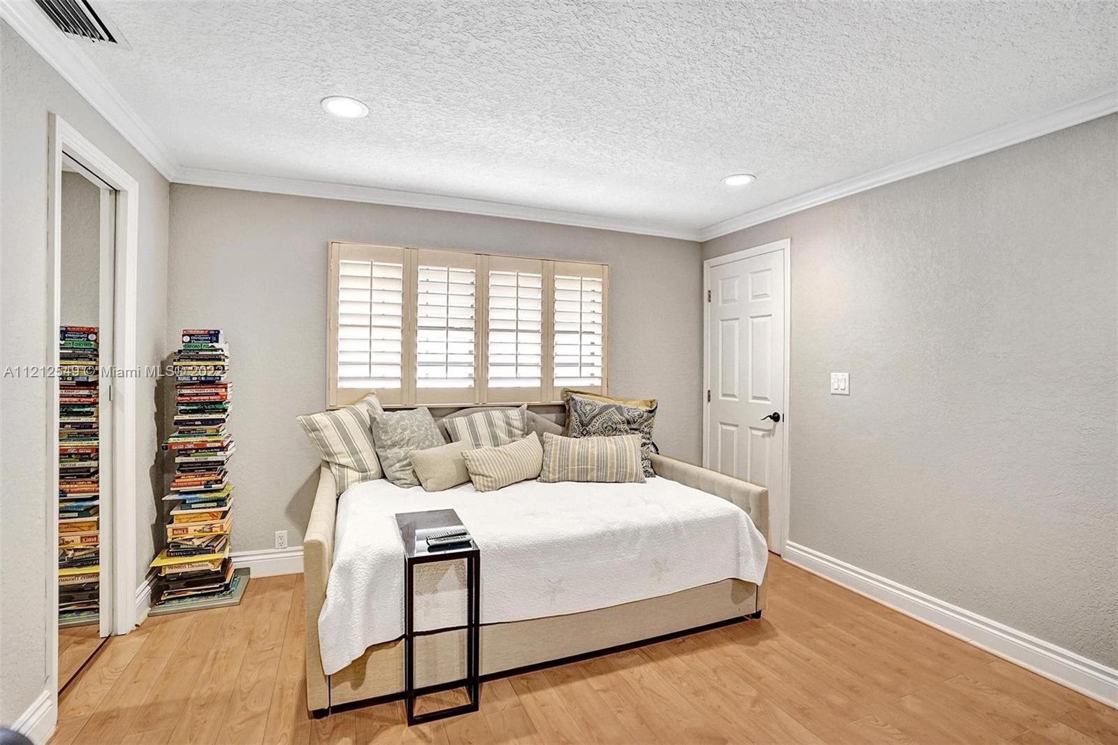 7360 Southwest 16th Street Plantation, FL 33317 - Photo 53 of 70 a bed room with a bed and a window