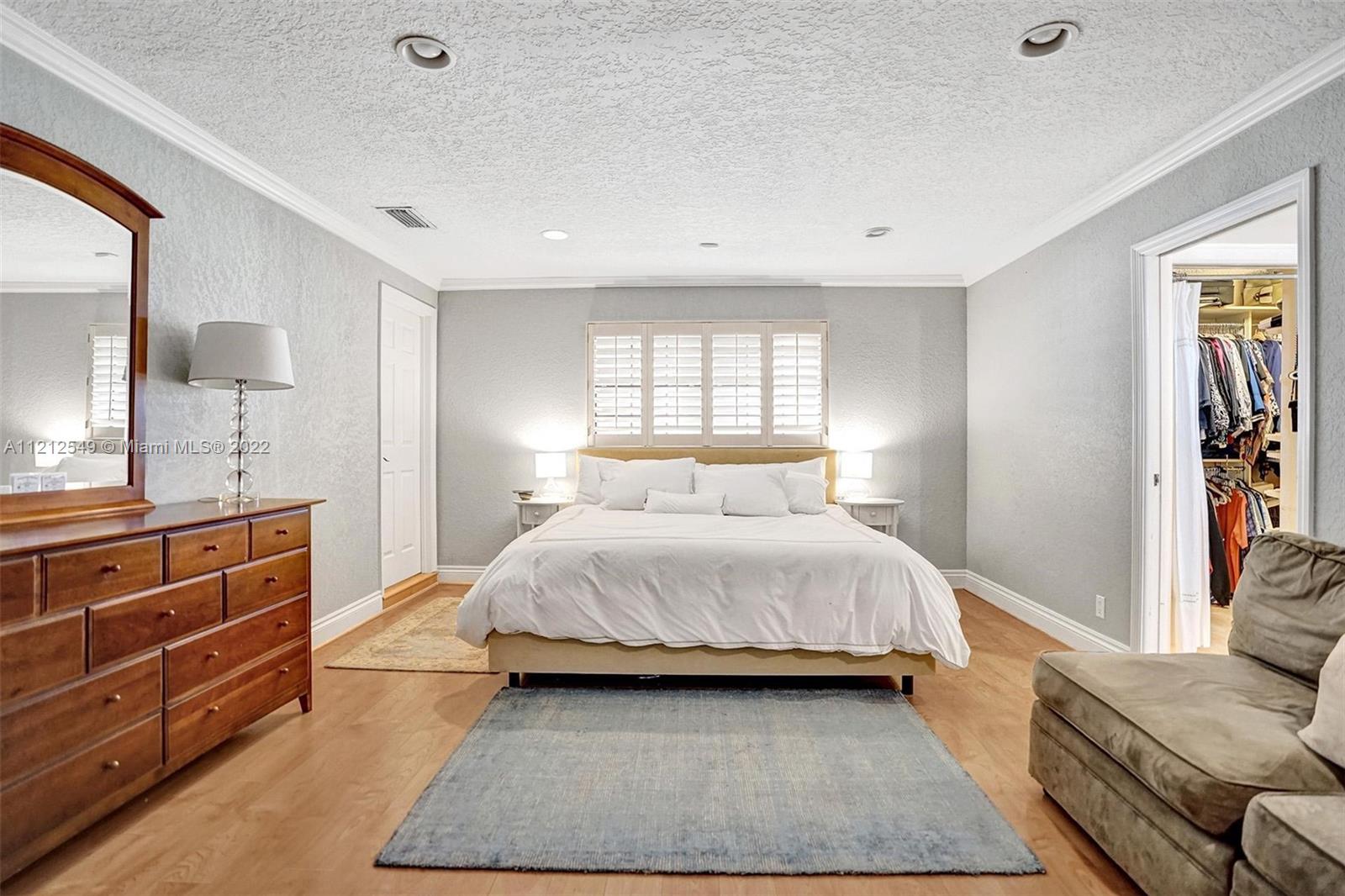 7360 Southwest 16th Street Plantation, FL 33317 - Photo 56 of 70 a bedroom with a large bed and a dresser
