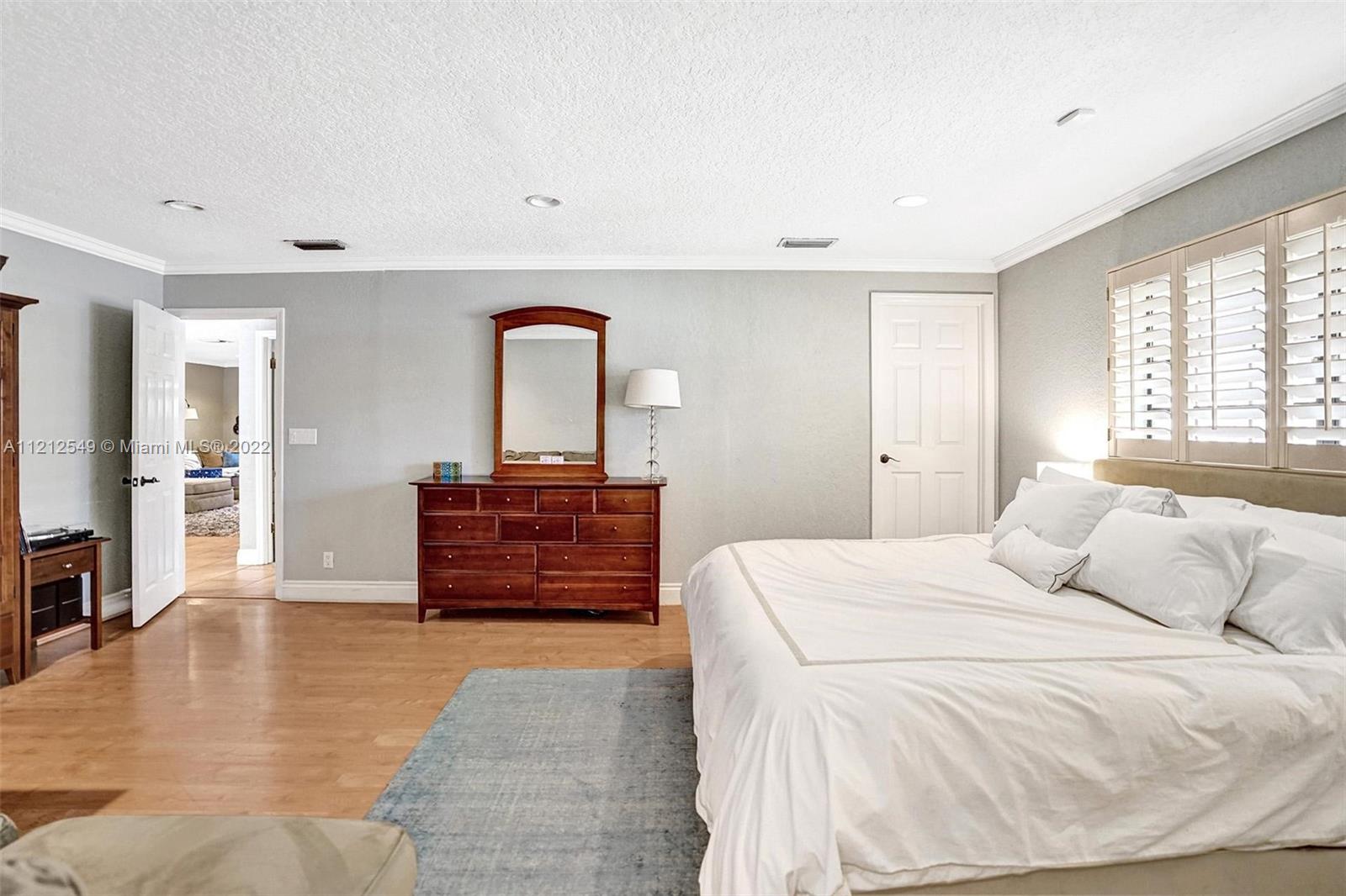 7360 Southwest 16th Street Plantation, FL 33317 - Photo 58 of 70 a bedroom with a bed and a flat screen television