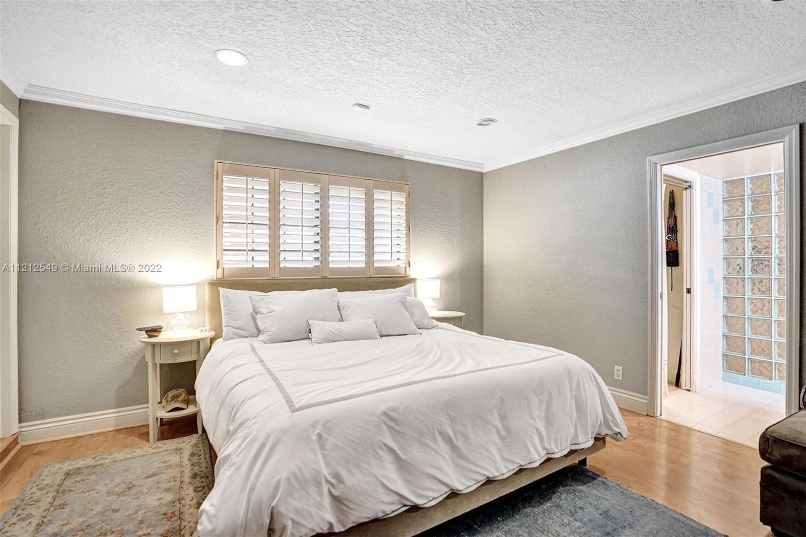 7360 Southwest 16th Street Plantation, FL 33317 - Photo 59 of 70 a bedroom with a bed and a large window