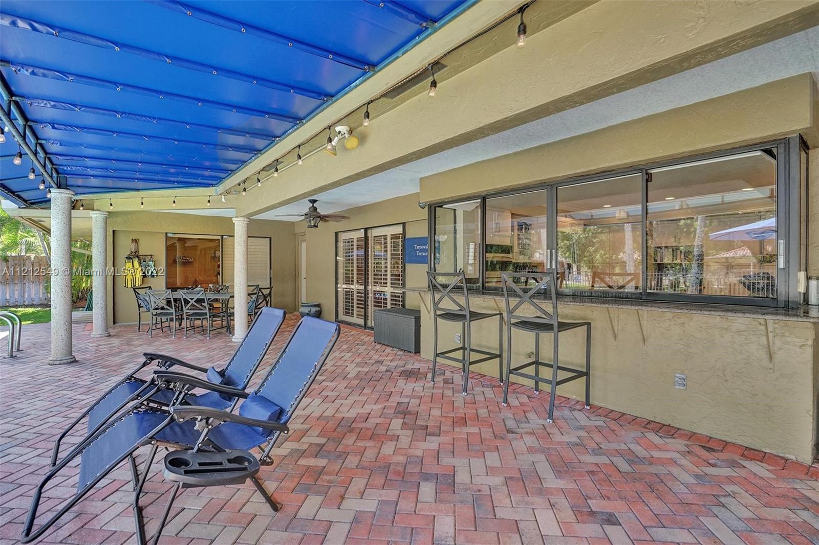 7360 Southwest 16th Street Plantation, FL 33317 - Photo 6 of 70 a view of a patio with table and chairs with wooden floor and fence