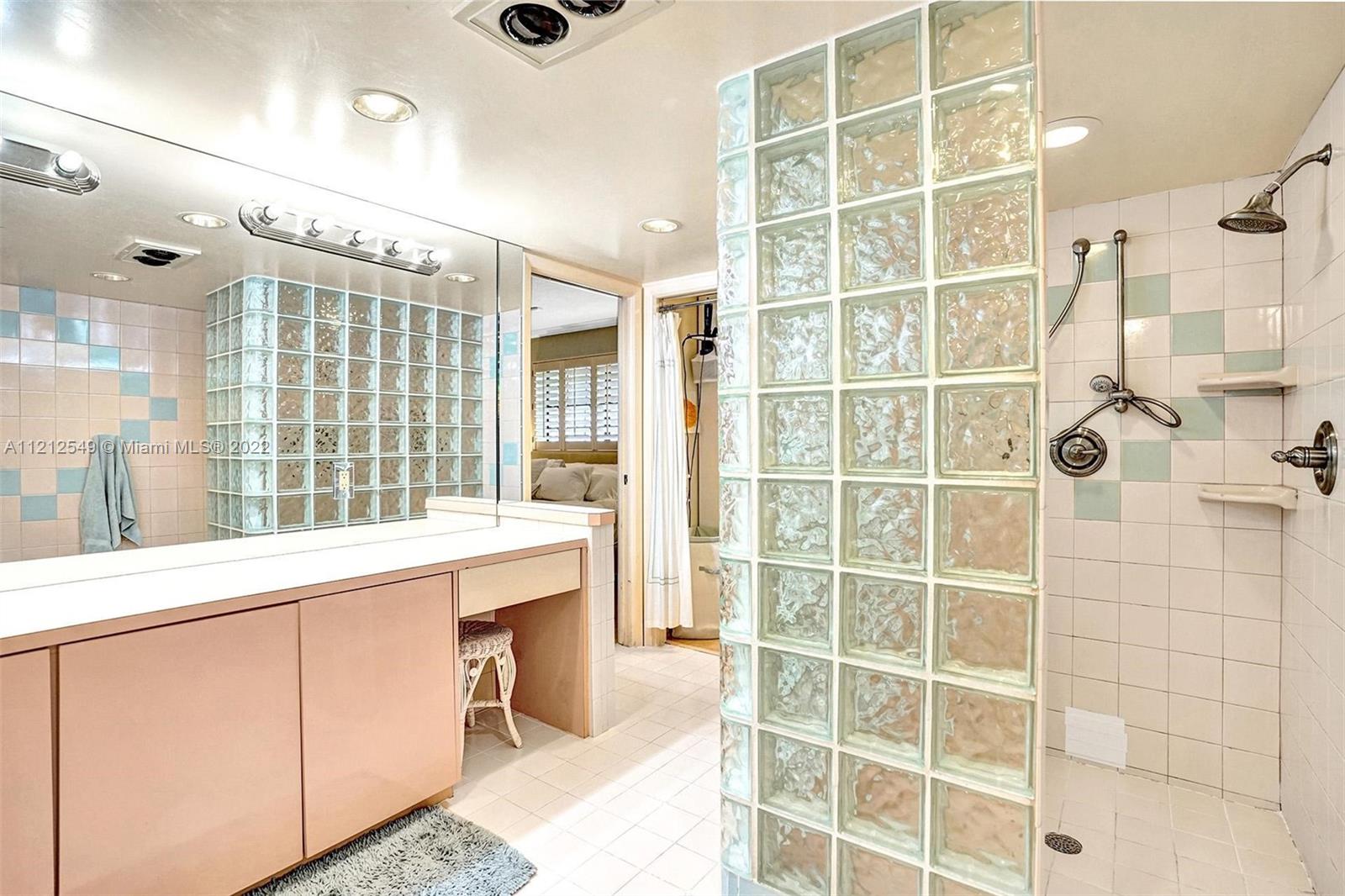 7360 Southwest 16th Street Plantation, FL 33317 - Photo 62 of 70 a bathroom with a double vanity sink a mirror and a shower