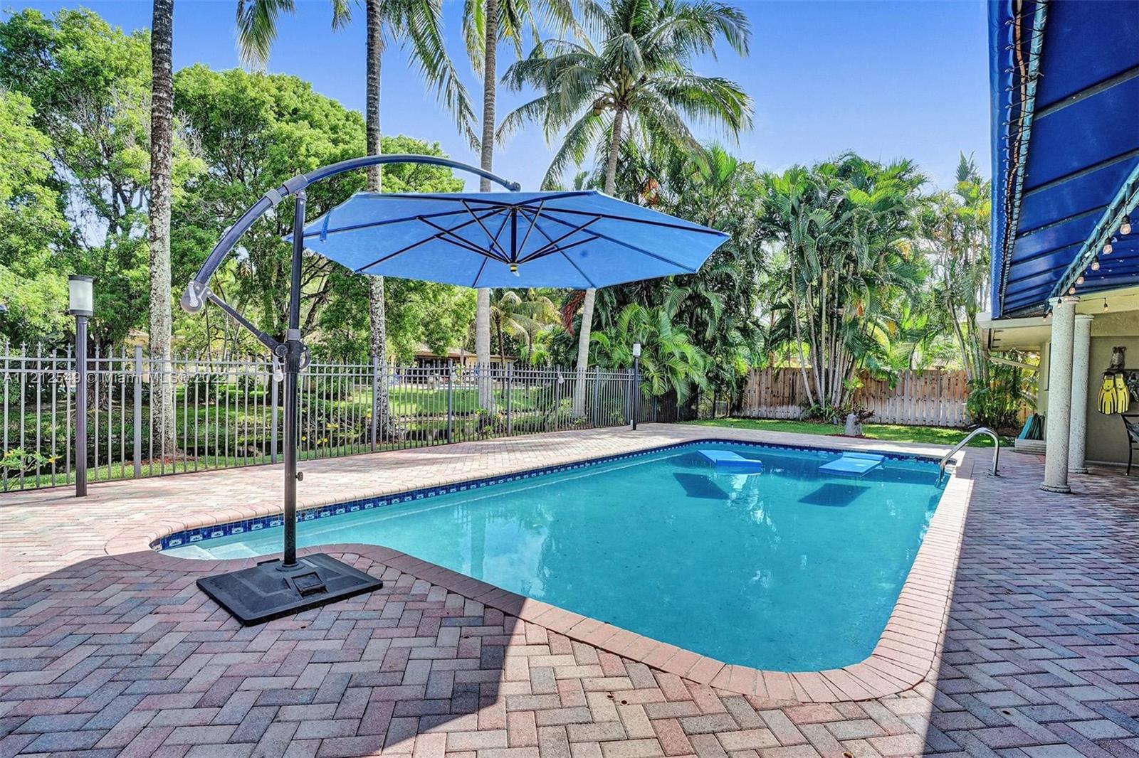 7360 Southwest 16th Street Plantation, FL 33317 - Photo 65 of 70 a view of a swimming pool with a table and chairs
