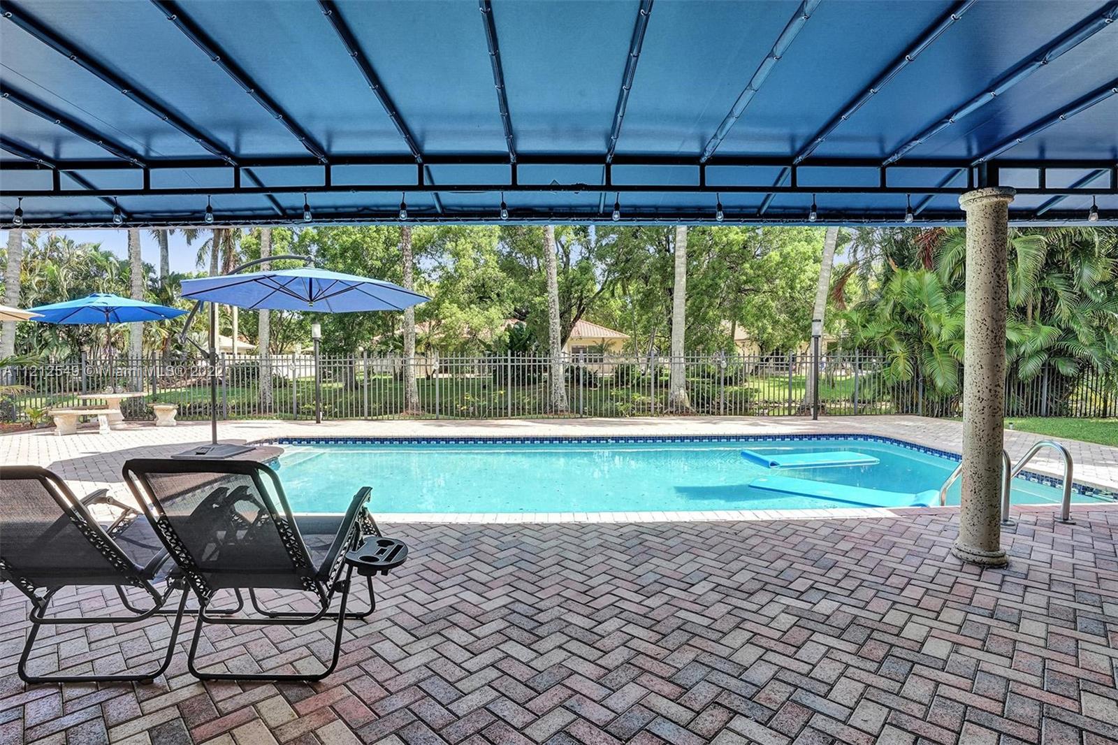 7360 Southwest 16th Street Plantation, FL 33317 - Photo 66 of 70 a couple of chairs and a table in the back yard