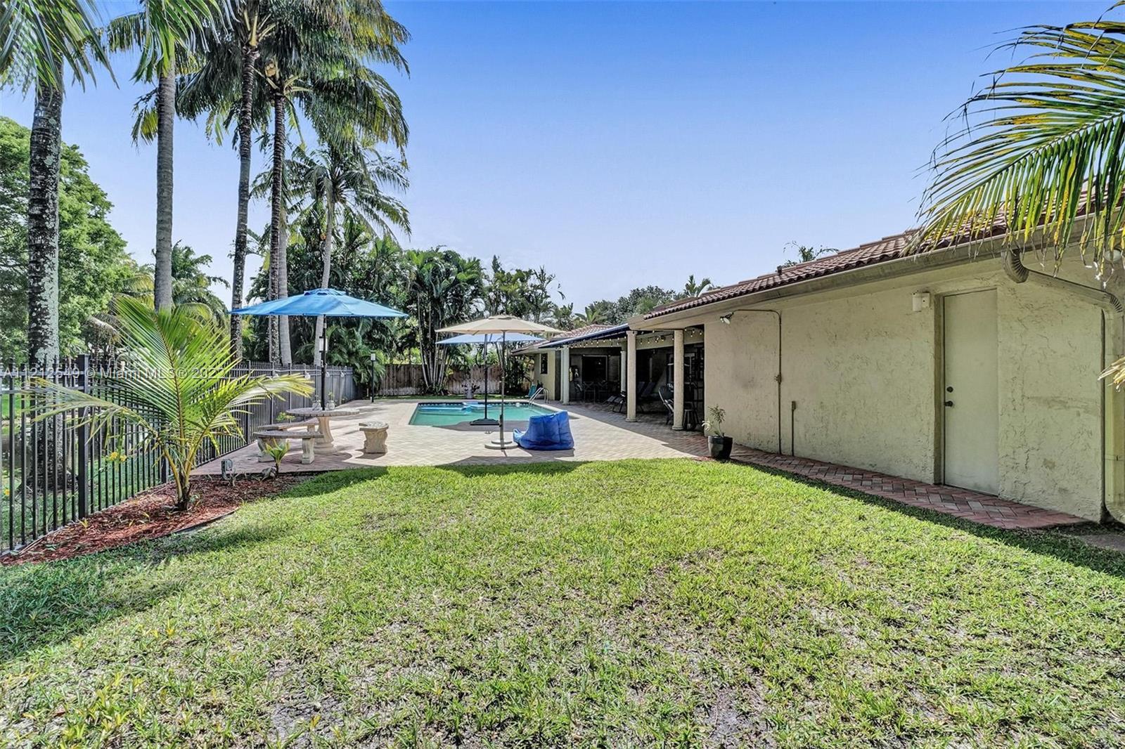 7360 Southwest 16th Street Plantation, FL 33317 - Photo 70 of 70 a view of a house with backyard sitting area and swimming pool