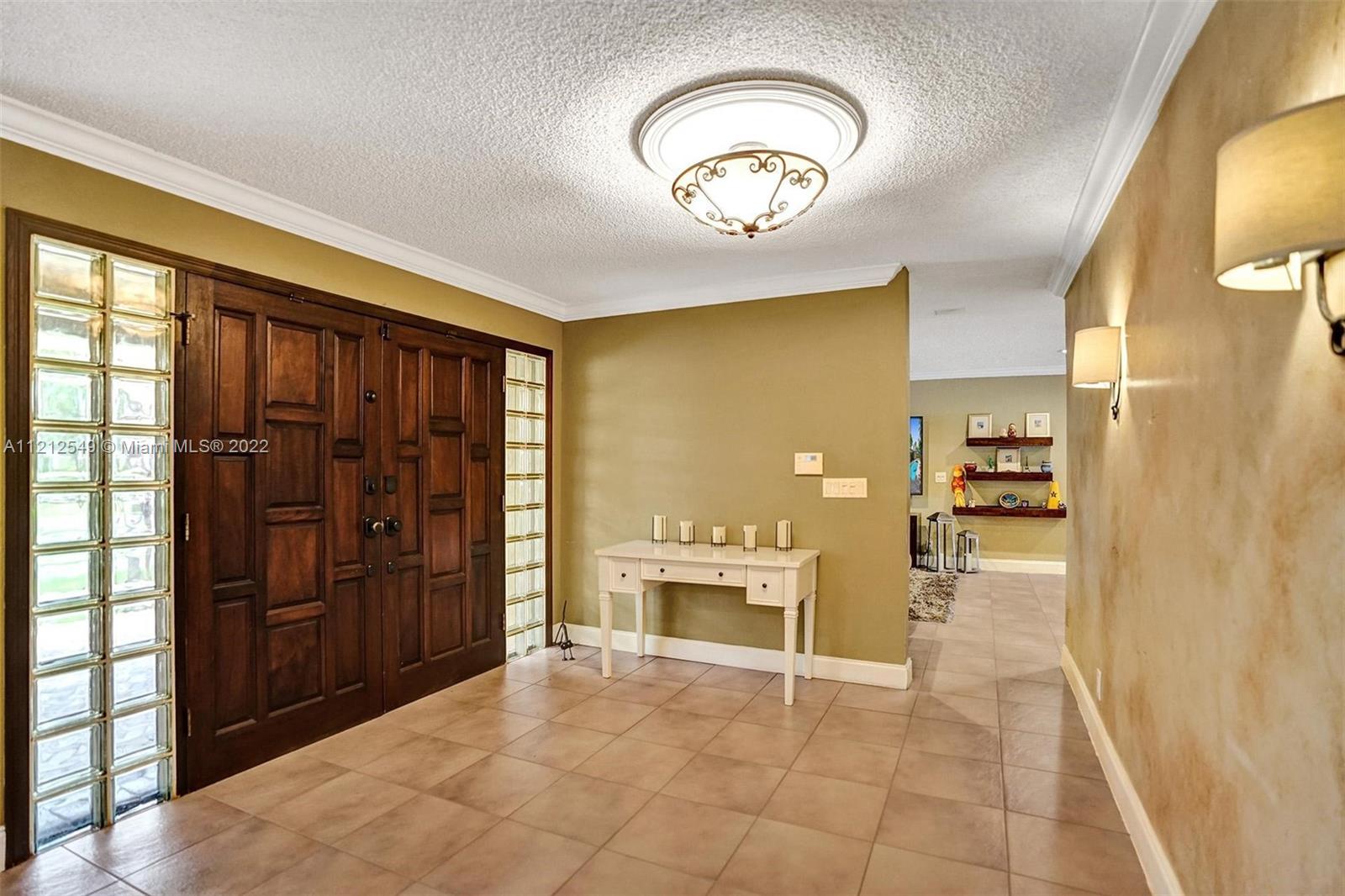 7360 Southwest 16th Street Plantation, FL 33317 - Photo 9 of 70 a view of a hallway with wooden shelves