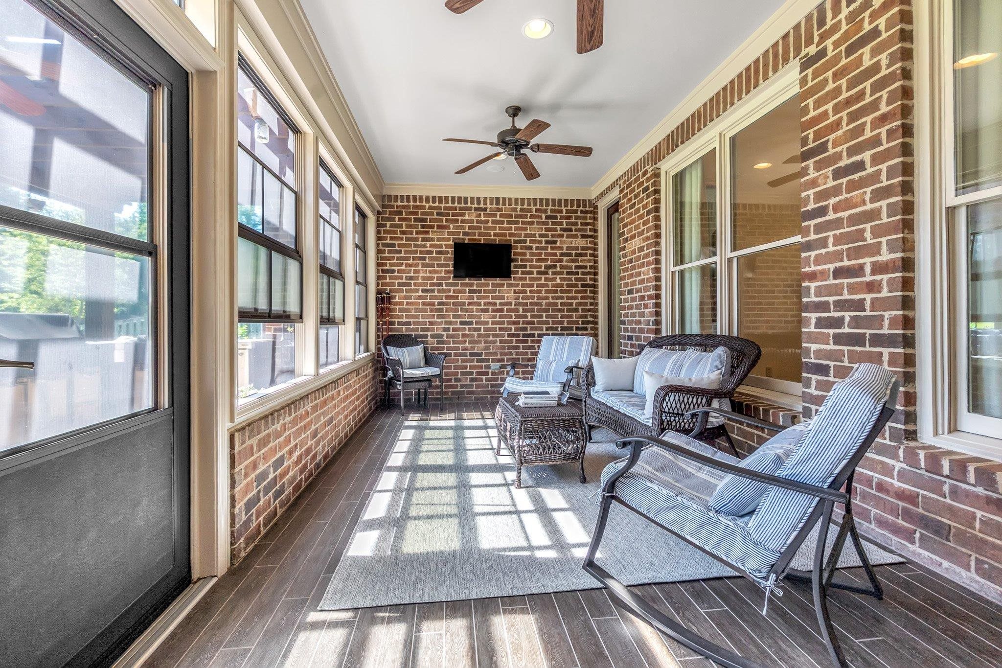 3246 North Hartwell Ridge Drive Collierville, TN 38017 - Photo 36 of 40 Covered outdoor patio featuring brick walls, wood-finish flooring, multiple large windows, and a ceiling fan