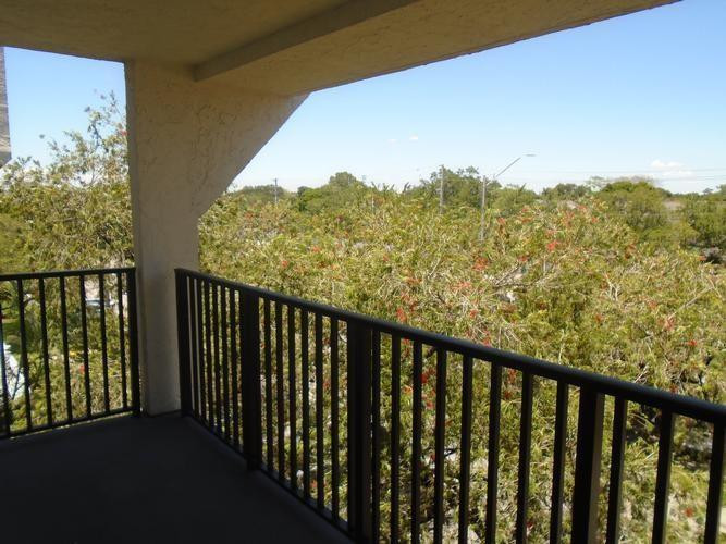6195 Rock Island Road, Unit 402 Tamarac, FL 33319 - Photo 12 of 23 a balcony with an outdoor view