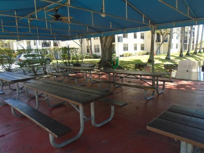 6195 Rock Island Road, Unit 402 Tamarac, FL 33319 - Photo 20 of 23 a view of swimming pool with outdoor seating