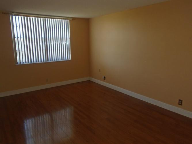 6195 Rock Island Road, Unit 402 Tamarac, FL 33319 - Photo 8 of 23 a view of a livingroom with wooden floor and a window