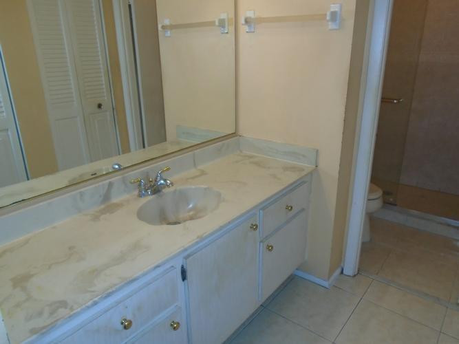 6195 Rock Island Road, Unit 402 Tamarac, FL 33319 - Photo 10 of 23 a bathroom with a granite countertop sink and a mirror