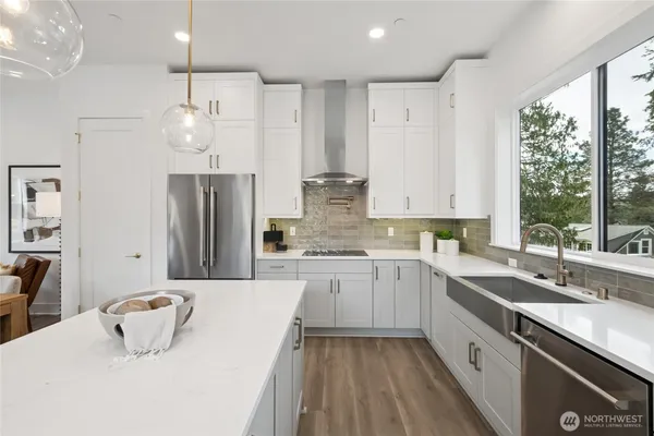 a kitchen with a sink refrigerator and window
