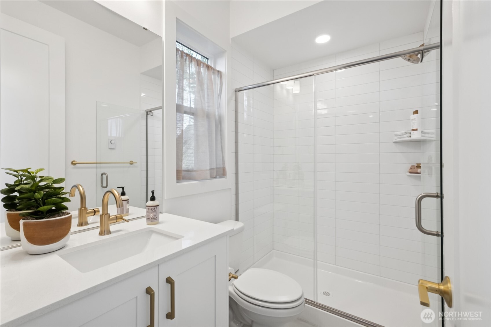 18809 99th Place Northeast, Unit C Bothell, WA 98011 - Photo 6 of 35 a bathroom with a sink a toilet and shower