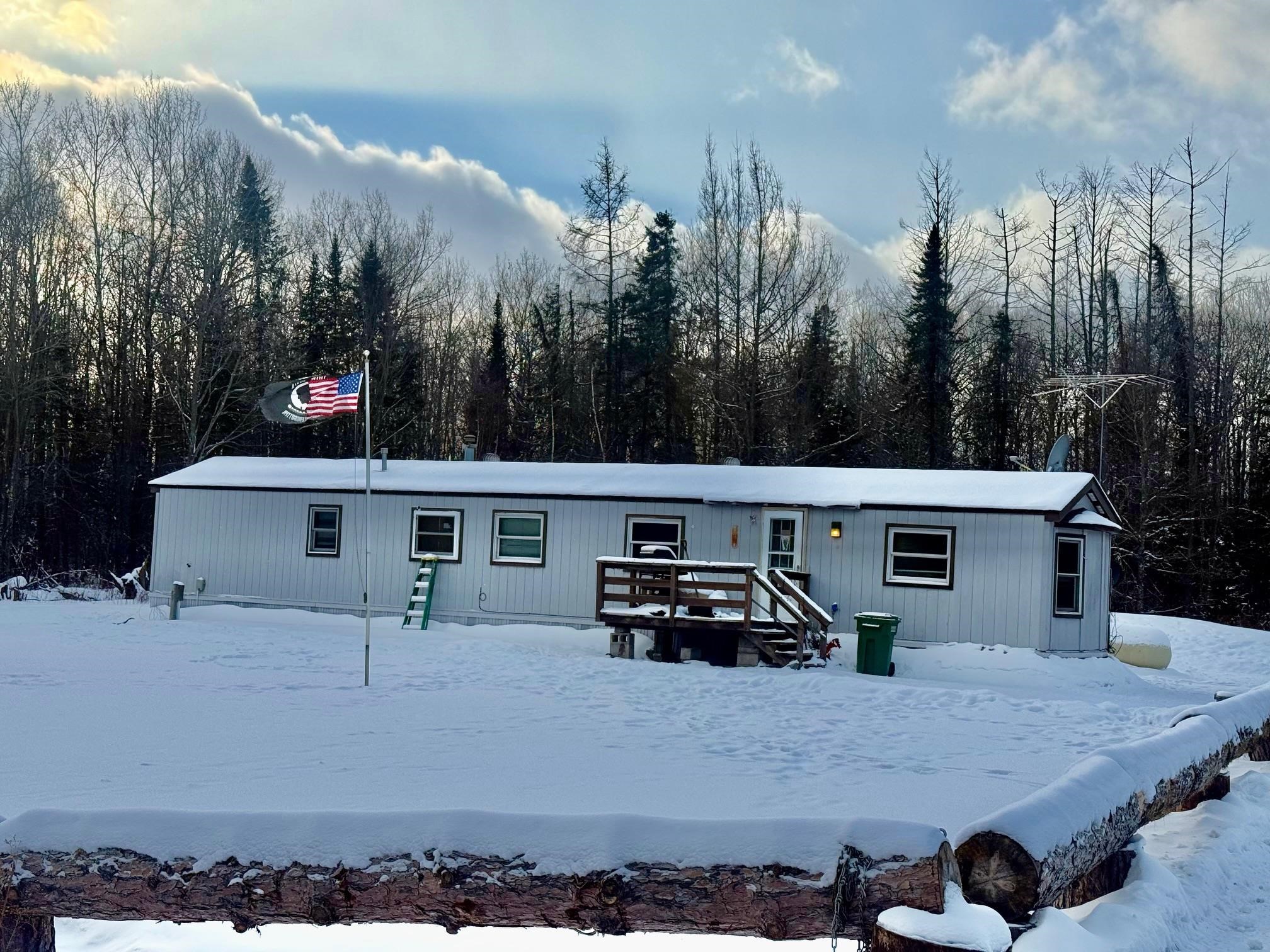 View of front facade with a view of trees