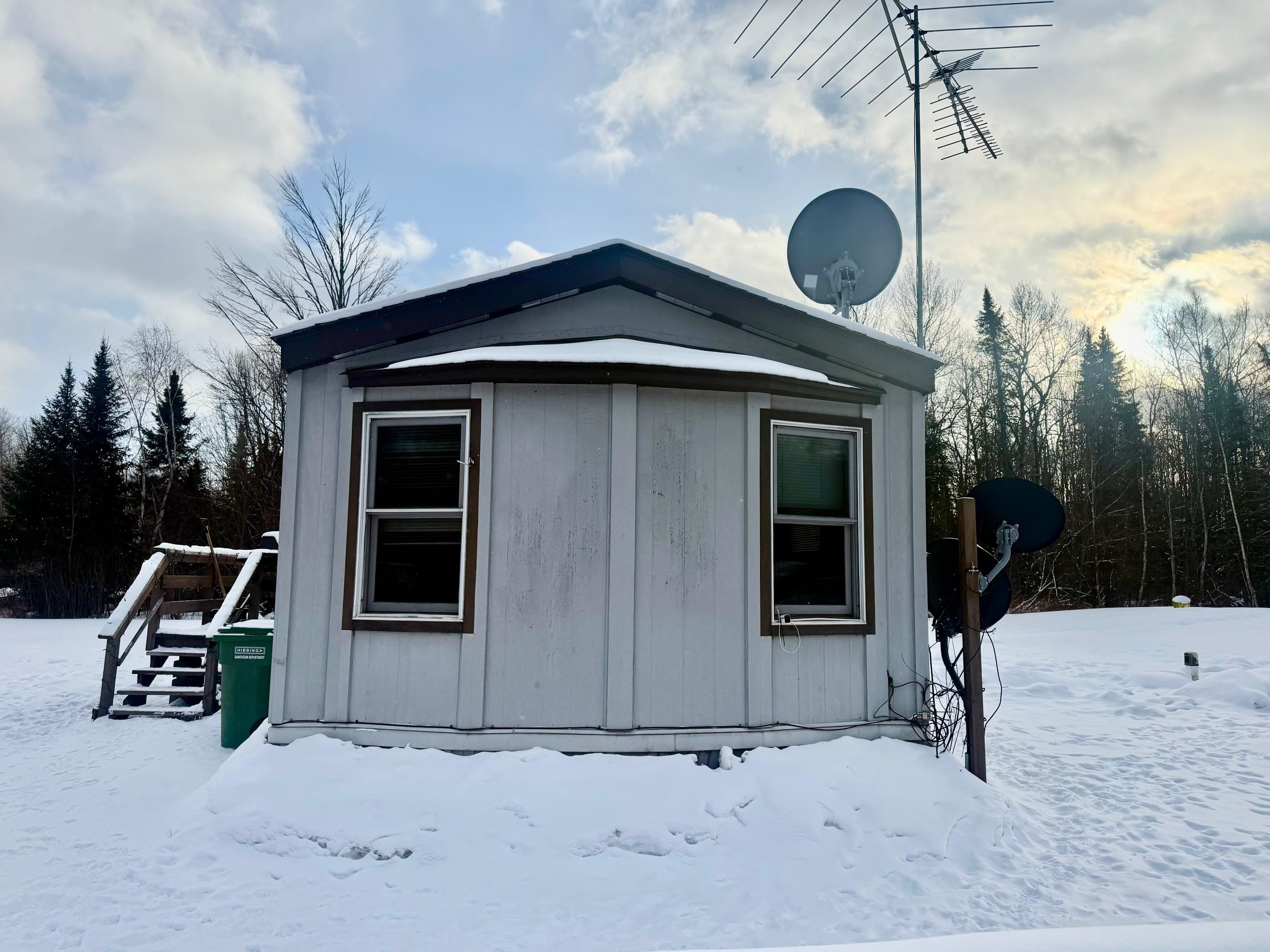 3031 South Leighton Road Hibbing, MN 55746 - Photo 3 of 8 Snow covered structure with a storage shed