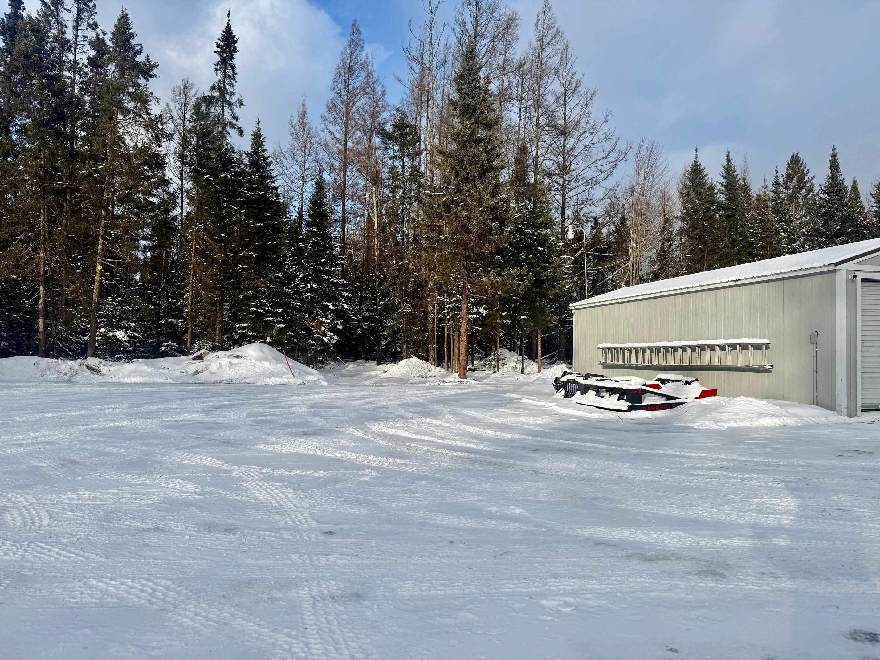 3031 South Leighton Road Hibbing, MN 55746 - Photo 4 of 8 Yard layered in snow featuring an outdoor structure