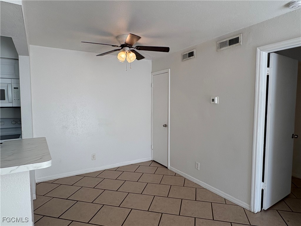 2855 Winkler Avenue, Unit 113 Fort Myers, FL 33916 - Photo 5 of 24 a view of an empty room and chandelier fan