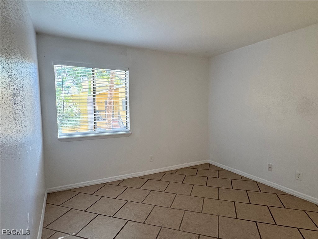 2855 Winkler Avenue, Unit 113 Fort Myers, FL 33916 - Photo 10 of 24 a view of an empty room with a window