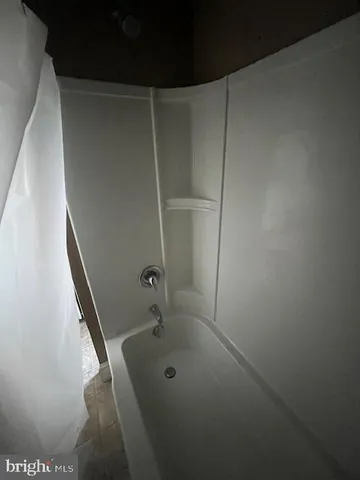 a bathroom with a tub and sink