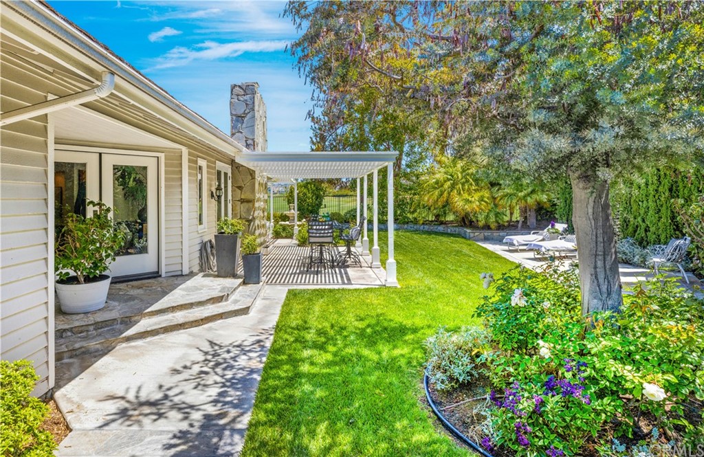 13 Guadalmina Drive Dana Point, CA 92629 - Photo 7 of 26 a view of a patio with table and chairs potted plants and large tree