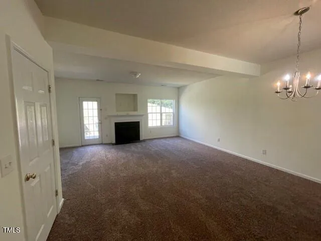 a view of empty room with window and fireplace