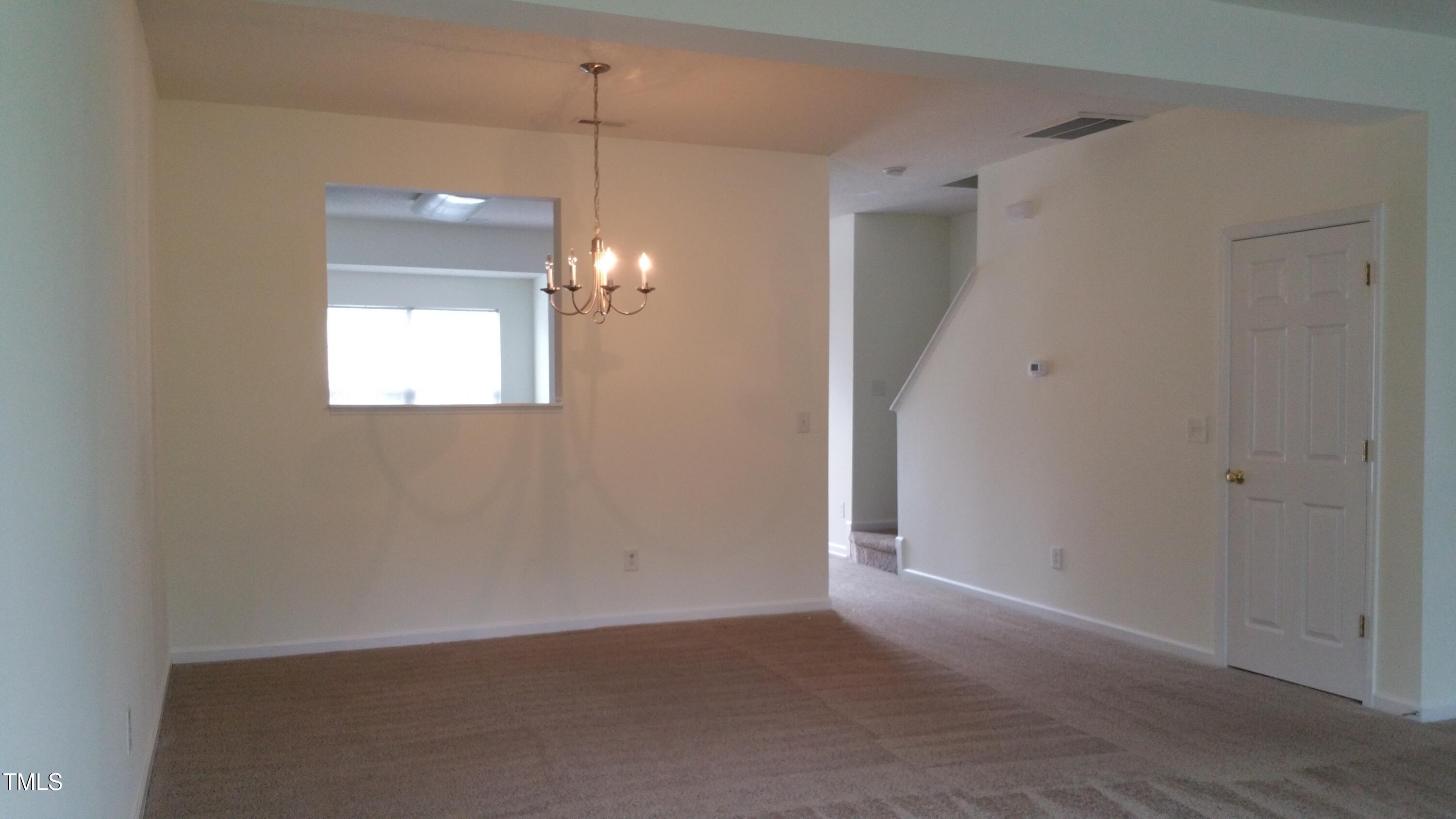 3363 Bridgeville Road Raleigh, NC 27610 - Photo 4 of 10 a view of an empty room with a window