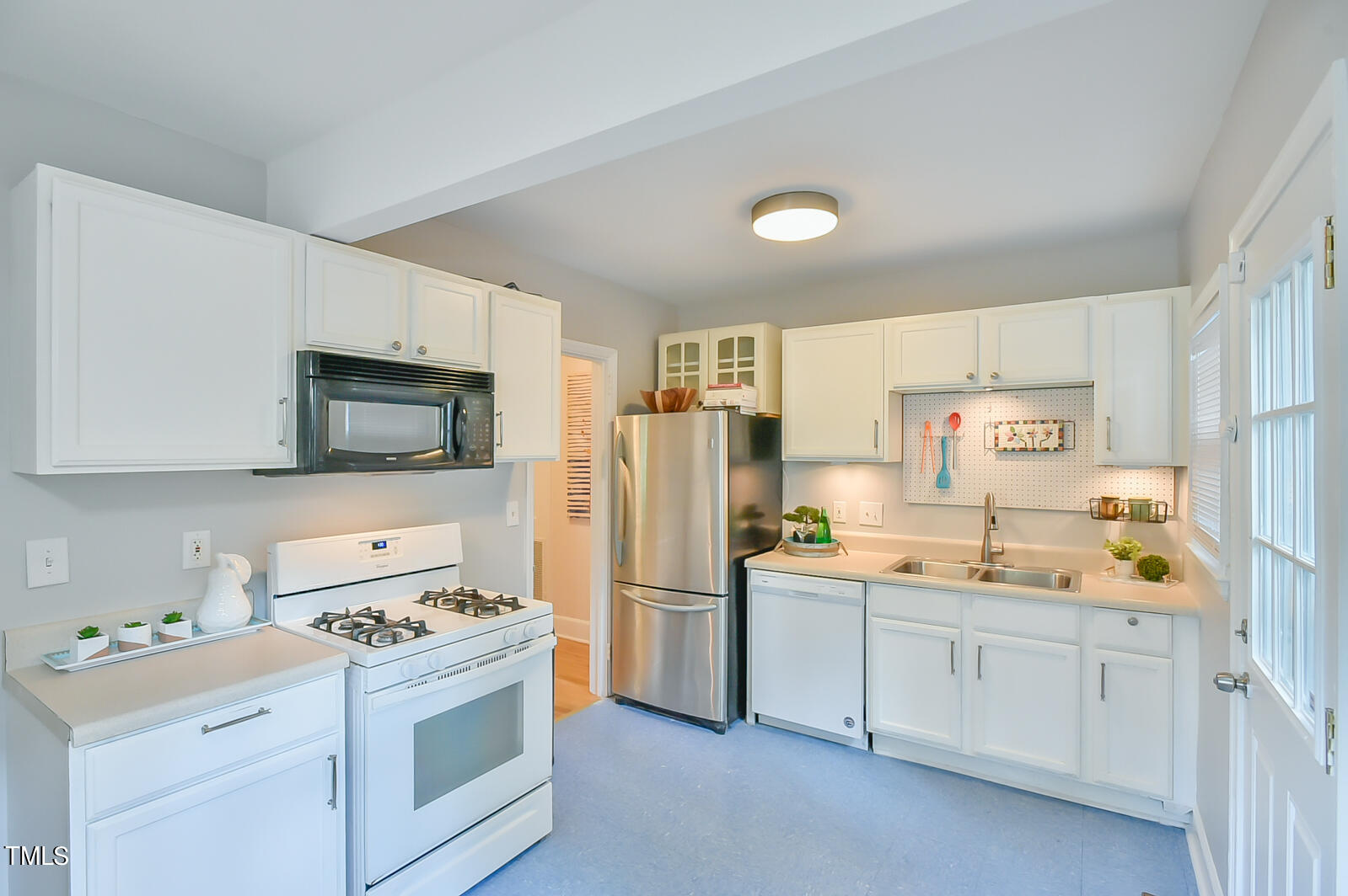 2605 Elgin Street Durham, NC 27704 - Photo 16 of 39 a kitchen with a sink stove and refrigerator