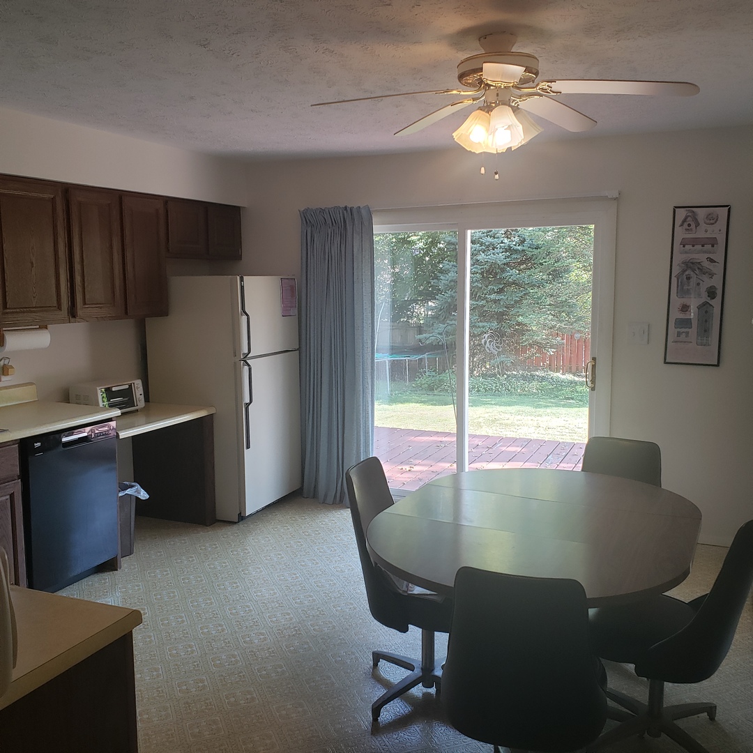1017 Morgan Street Normal, IL 61761 - Photo 3 of 15 a view of a dining room with furniture a chandelier and window