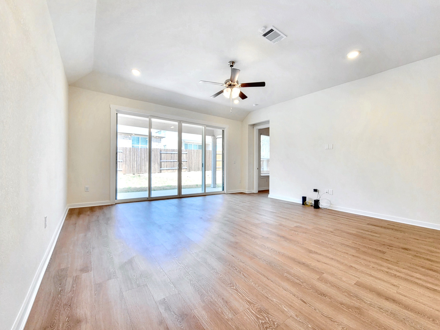 2329 Gabriels Horn Road Leander, TX 78641 - Photo 7 of 23 A spacious living area with wood flooring and sliding glass doors leading to the private yard.